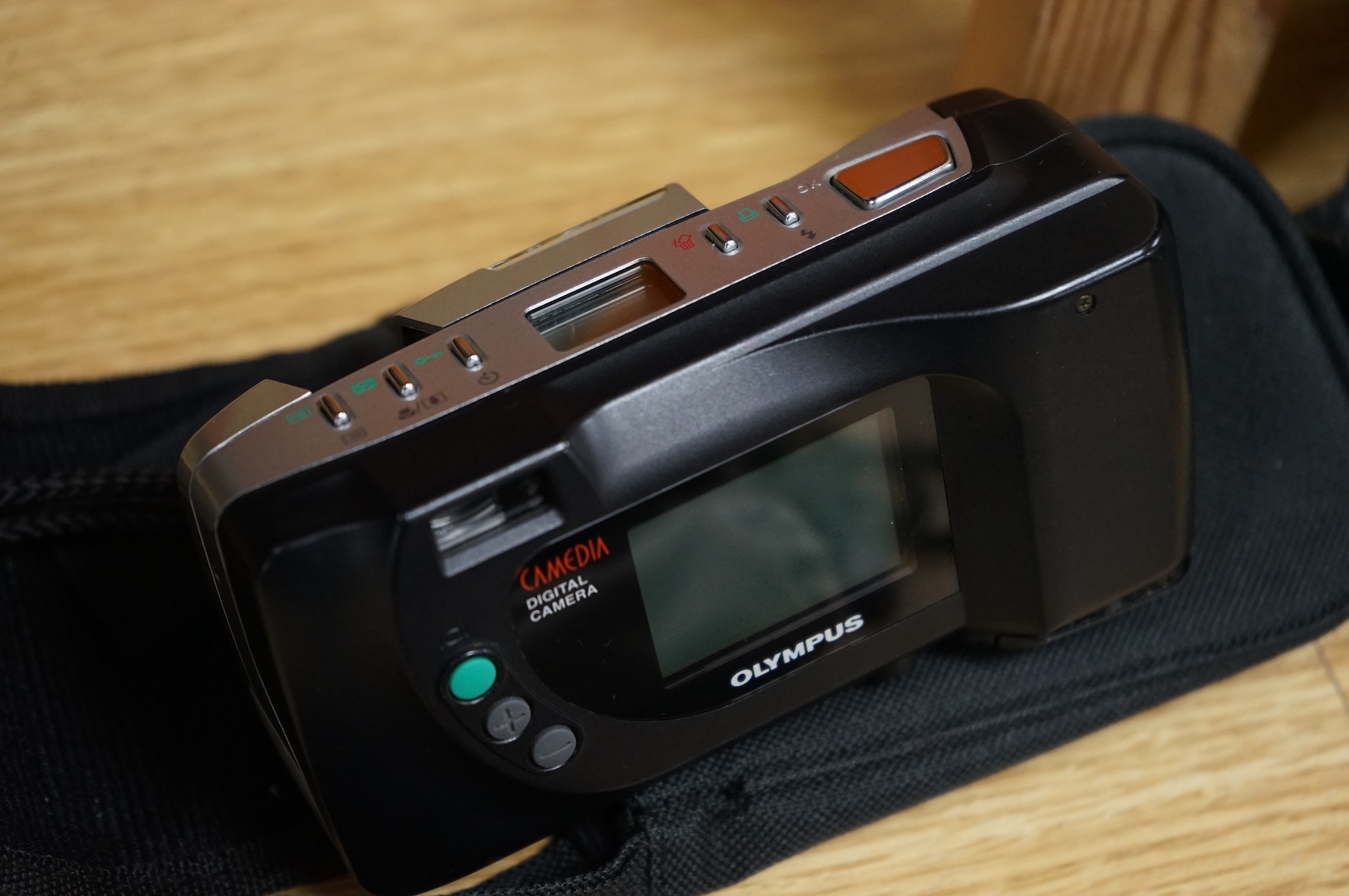 A cased Olympus 35SP camera, together with two more recent digital cameras